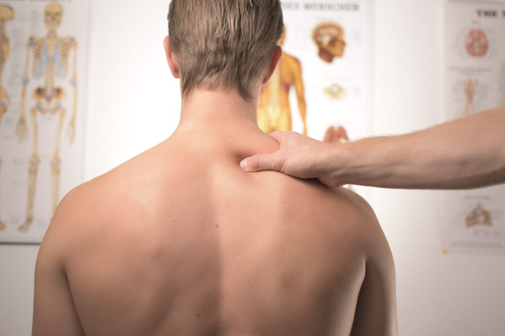 Doctor treating neck and shoulder pain